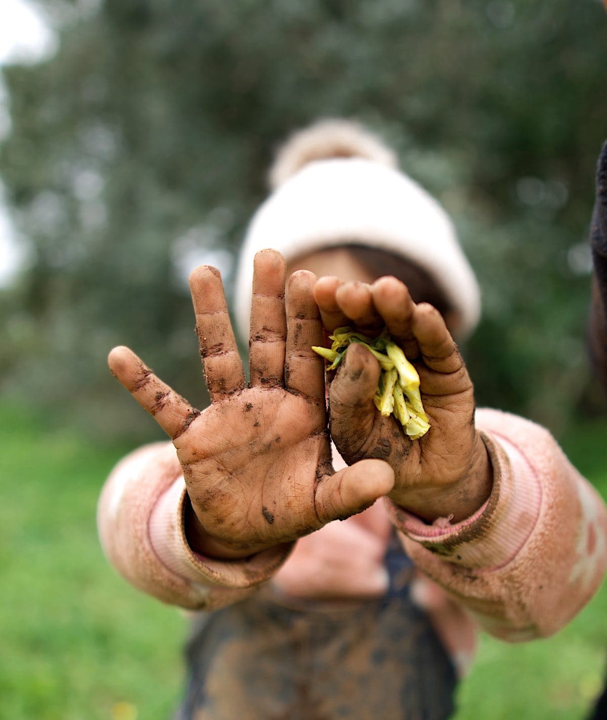 girl with muddy hands